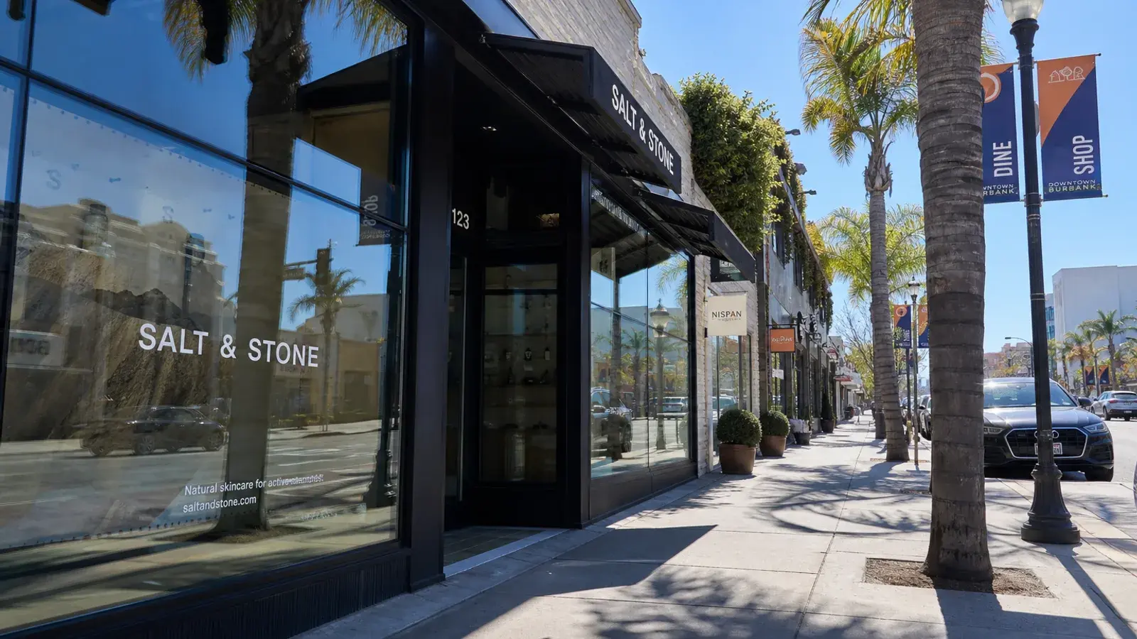 Downtown Burbank boutique street exteriors midday — breast augmentation lifestyle | SurgiSculpt®
