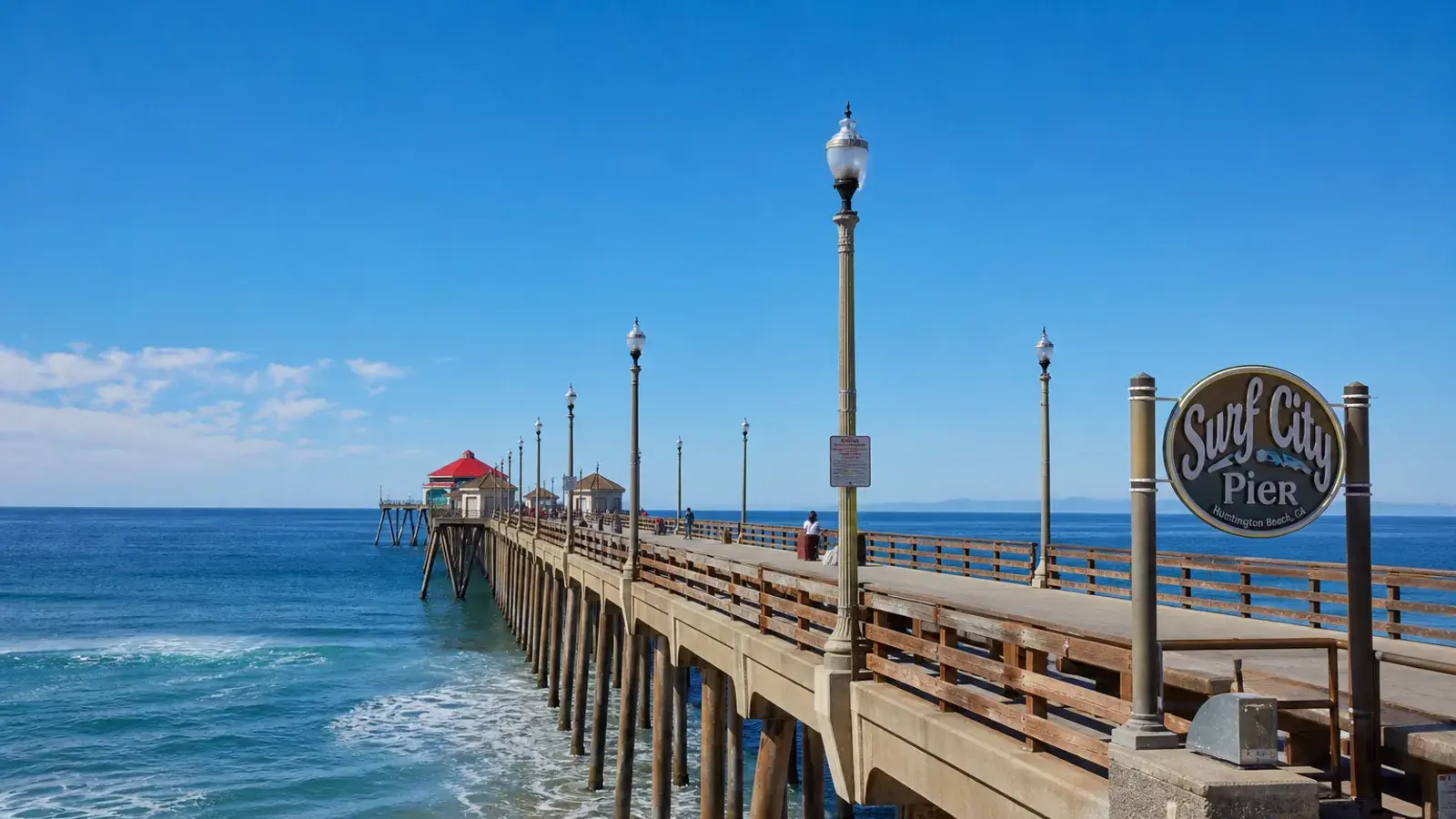 Huntington Beach pier walkway midday outdoor light — breast augmentation lifestyle | SurgiSculpt®