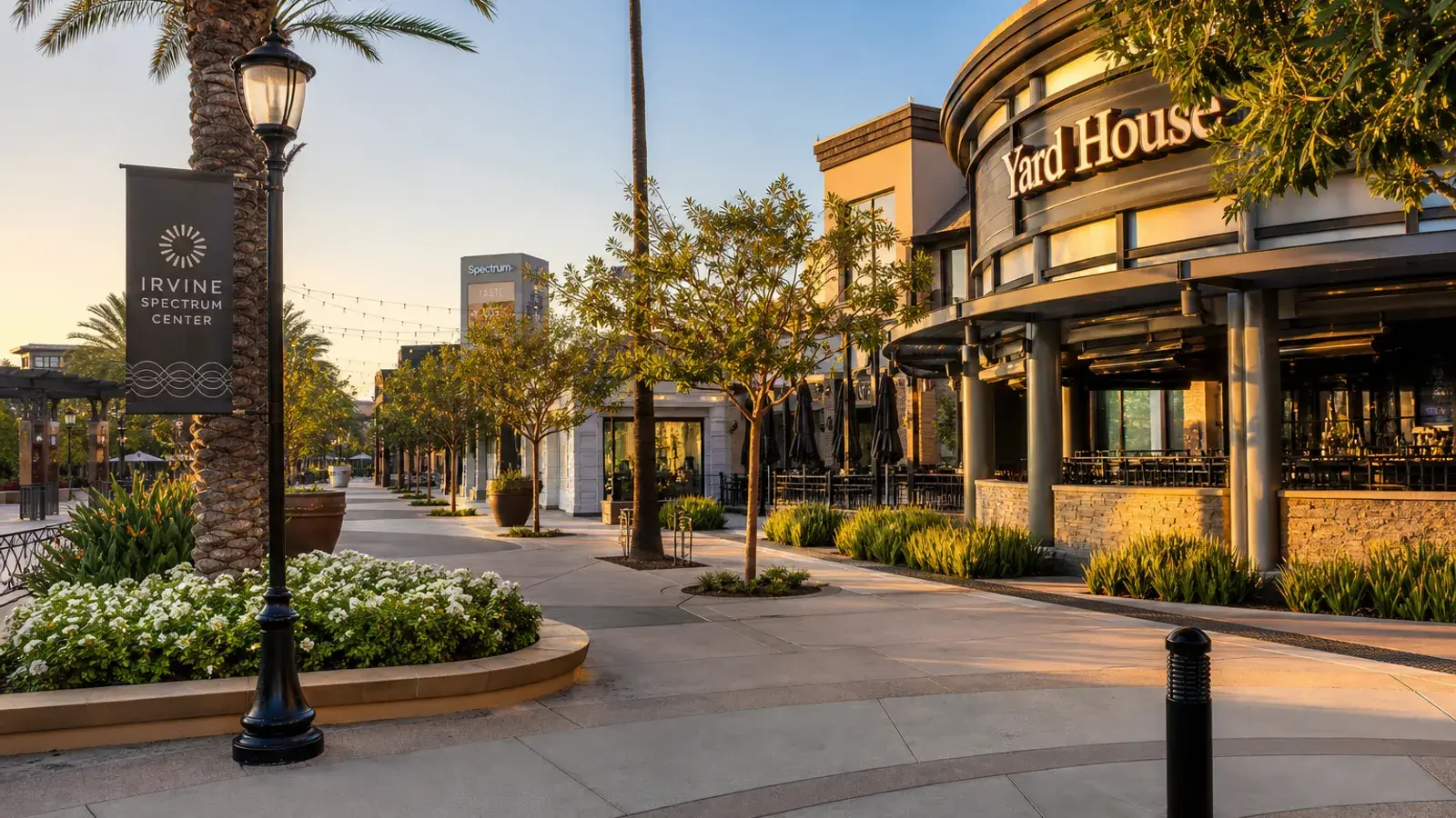 Irvine Spectrum outdoor plaza and tree-lined walkway at golden hour — HD Liposuction lifestyle | SurgiSculpt®