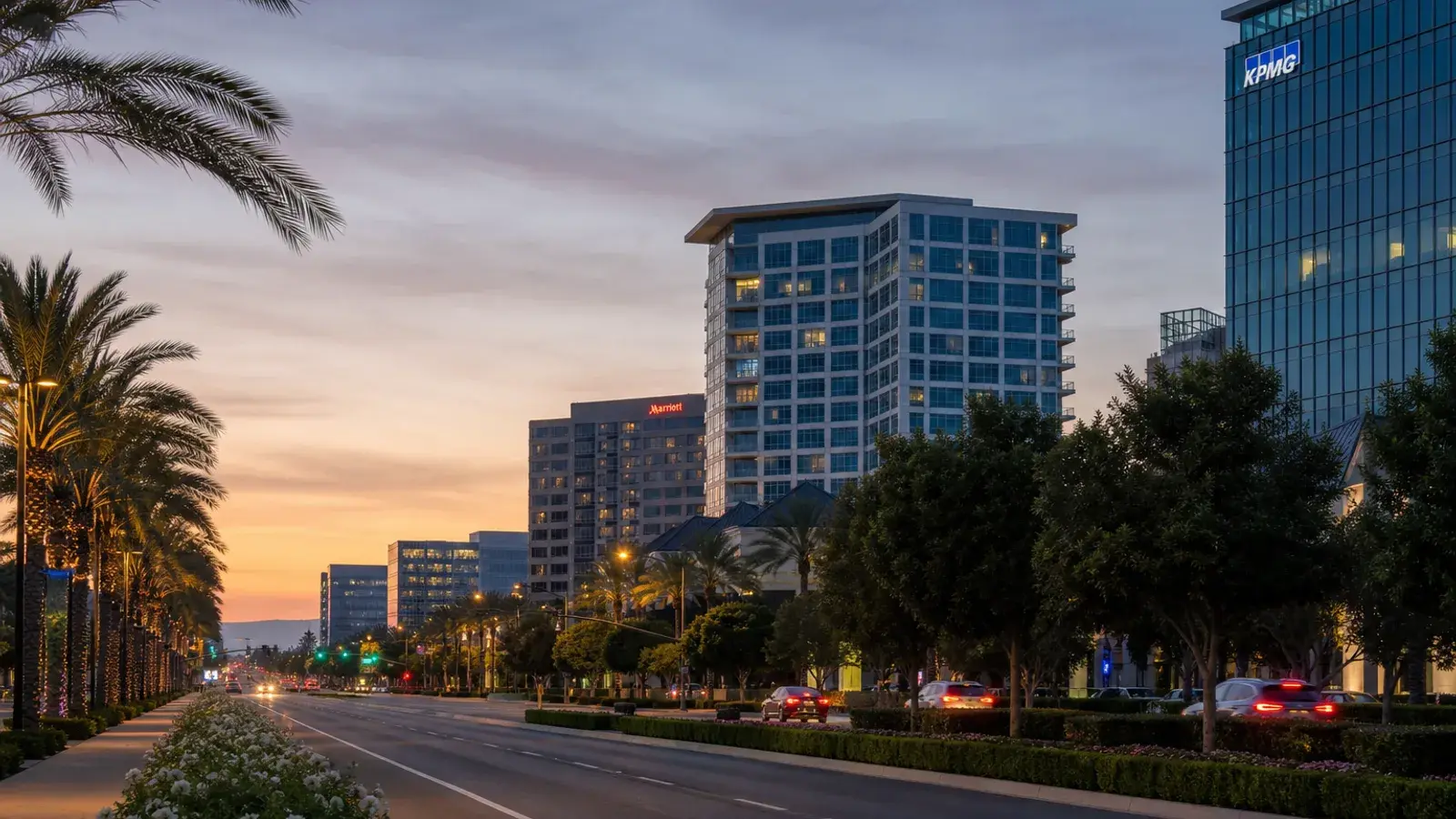 Irvine evening skyline glow over landscaped boulevards — mommy makeover mood | SurgiSculpt®