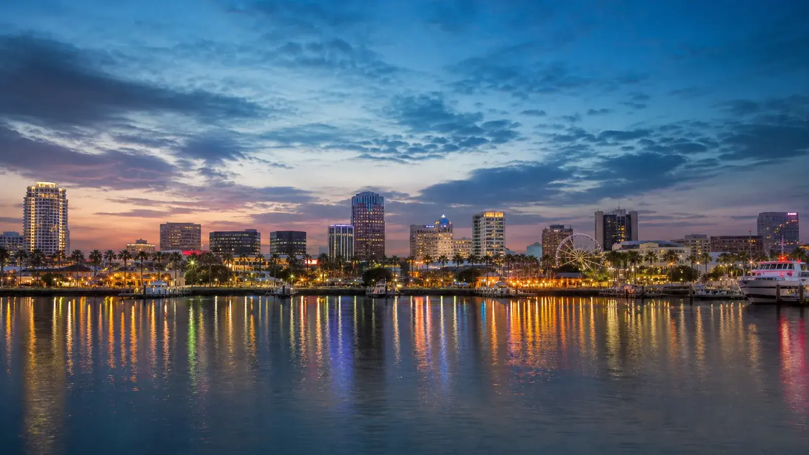 Long Beach downtown skyline across harbor water at dusk — HD Liposuction context | SurgiSculpt®