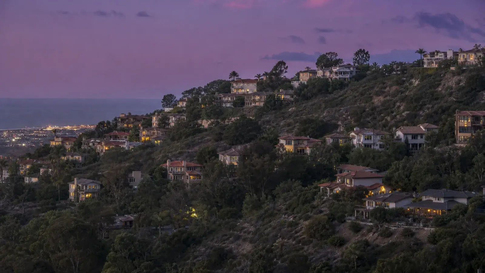 Soft evening light over Laguna Niguel hillside homes — mommy makeover coastal-adjacent mood | SurgiSculpt®