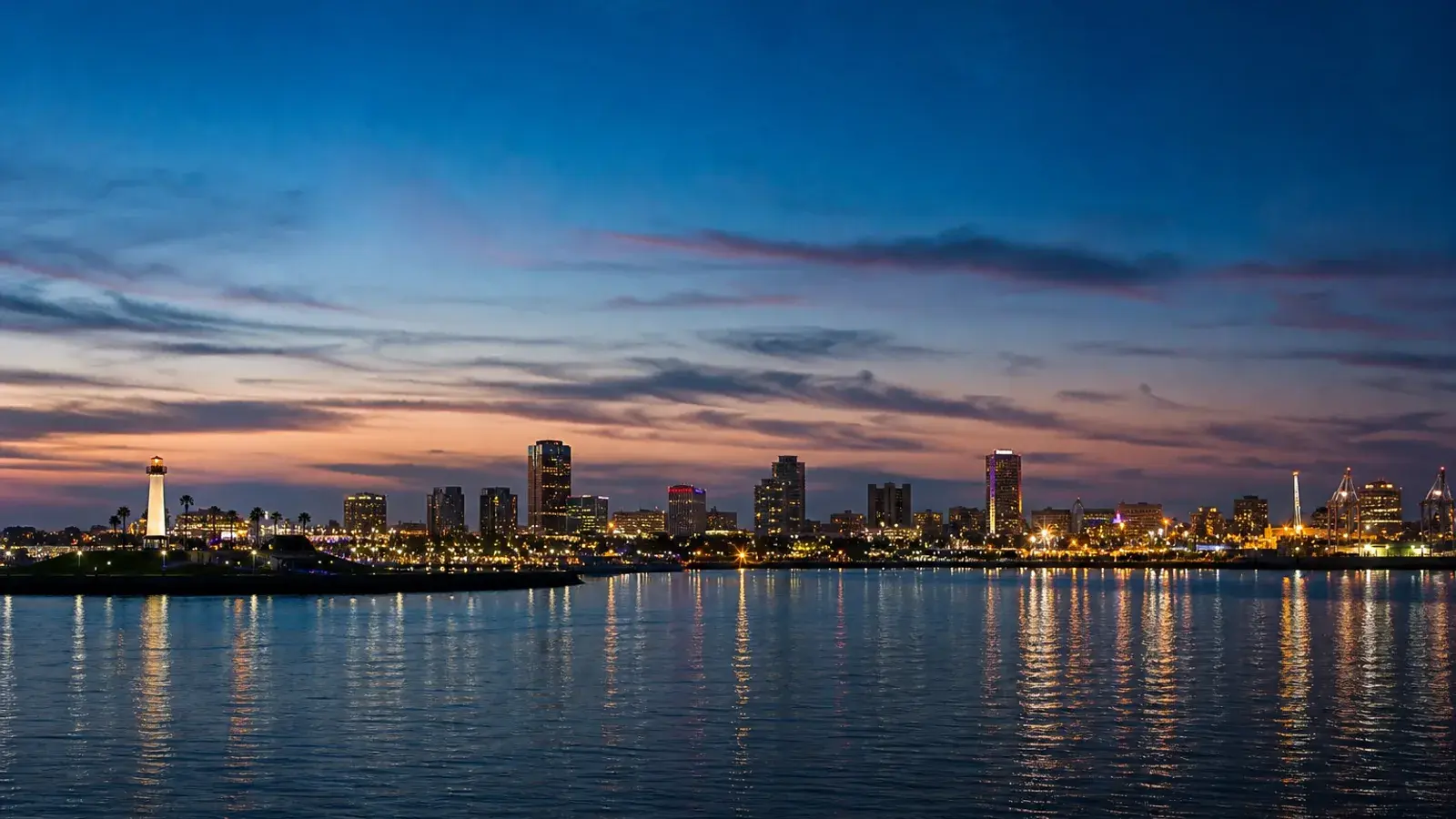 San Pedro harbor skyline soft dusk across calm water — HD Liposuction context | SurgiSculpt®