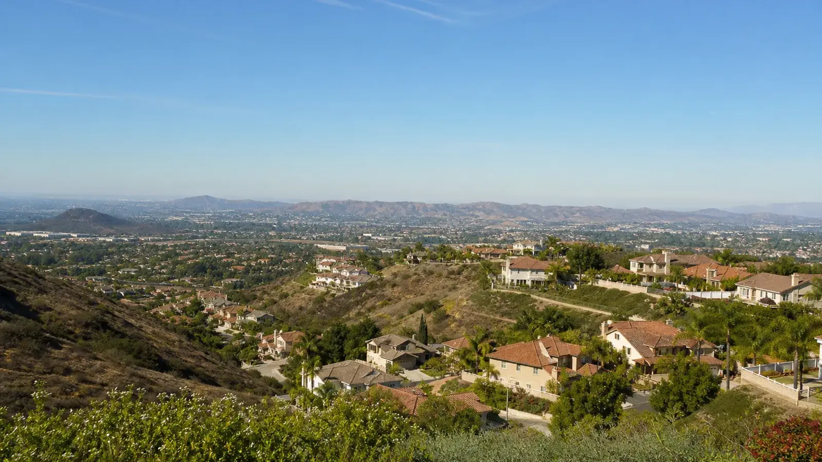 Anaheim Hills overlook with landscaped homes and open sky — breast augmentation lifestyle Anaheim Hills overlook with landscaped homes and open sky — breast augmentation lifestyle | SurgiSculpt®