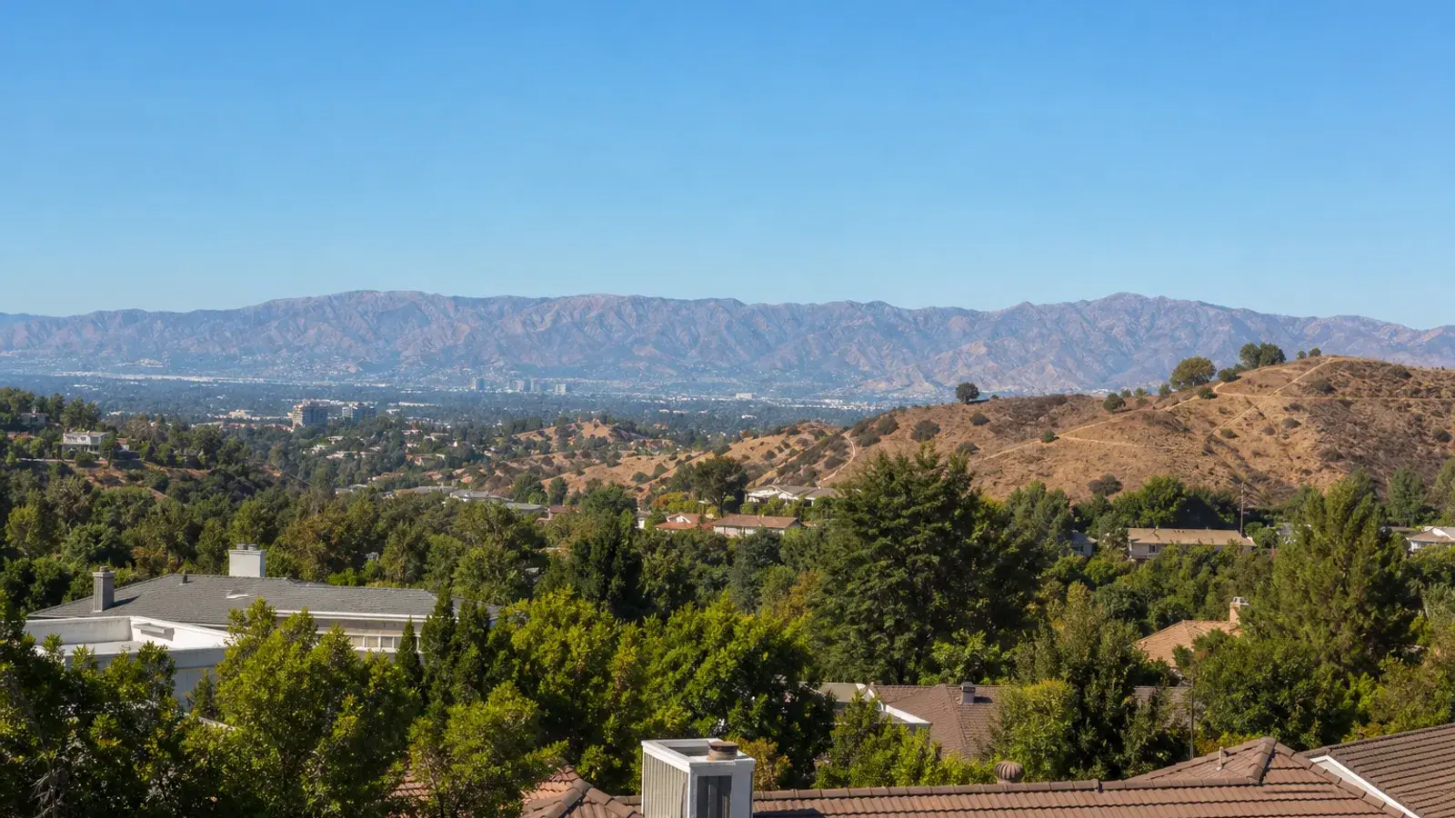 Encino hillside residential view toward Santa Monica Mountains — breast augmentation context Encino hillside residential view toward Santa Monica Mountains — breast augmentation context | SurgiSculpt®