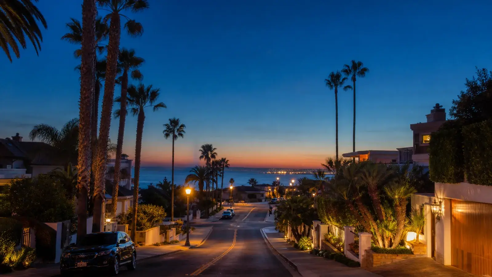 Palm-lined Newport Beach coastal street at blue hour — discreet gynecomastia logistics Palm-lined Newport Beach coastal street at blue hour — discreet gynecomastia logistics | SurgiSculpt®