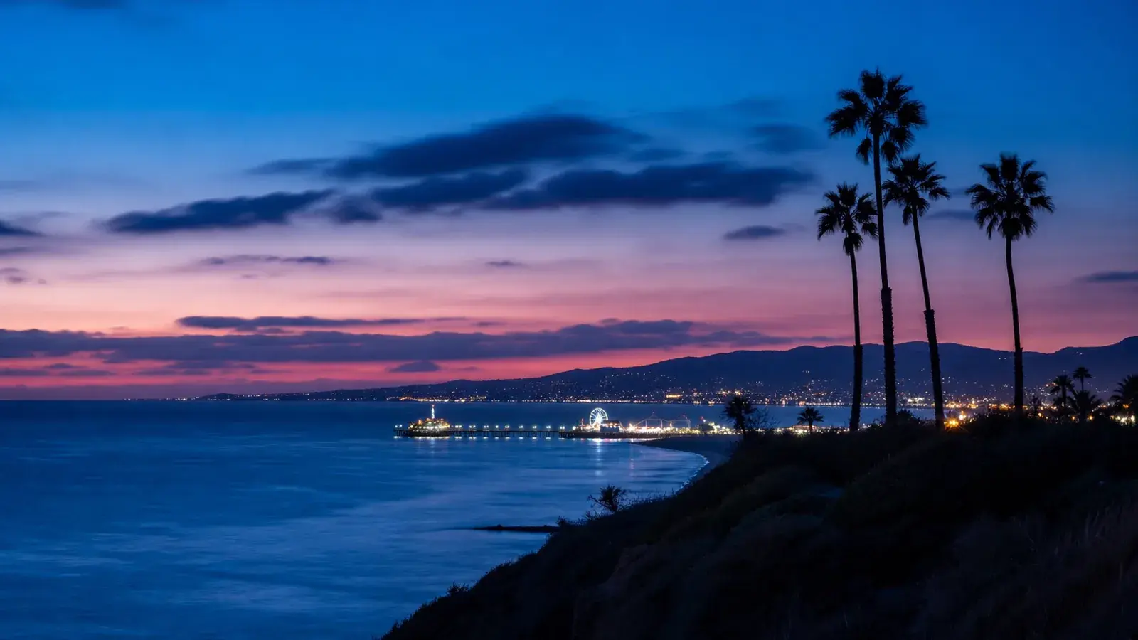 Santa Monica Bay blue hour with pier lights — mommy makeover mood Santa Monica Bay blue hour with pier lights — mommy makeover mood | SurgiSculpt®