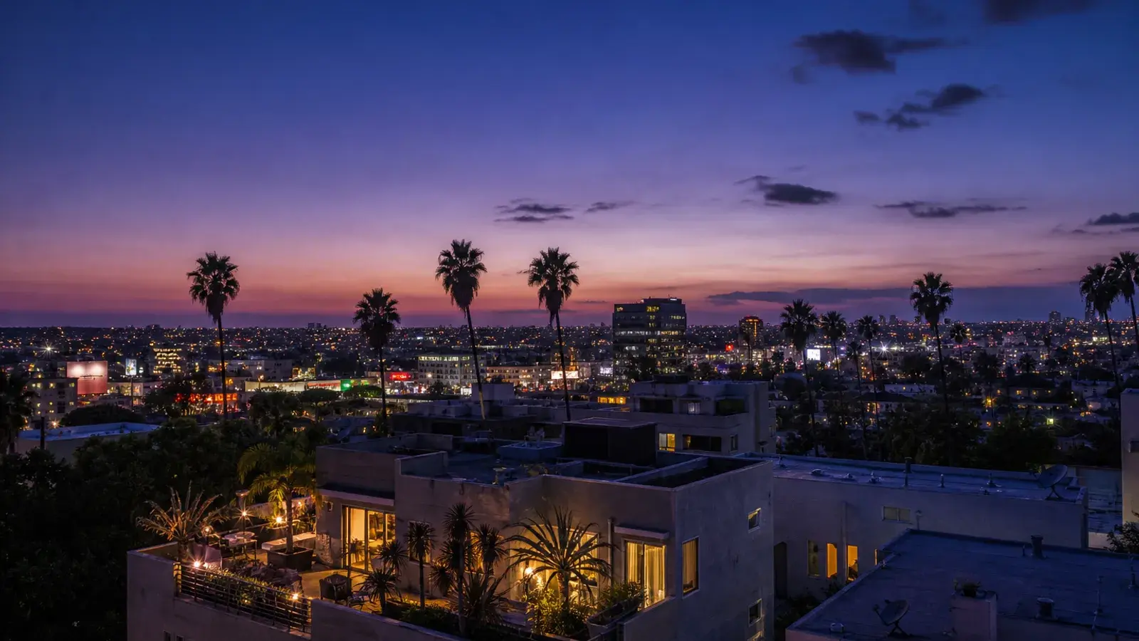 Twilight view over West Hollywood rooftops and palms — breast augmentation recovery mood Twilight view over West Hollywood rooftops and palms — breast augmentation recovery mood | SurgiSculpt®