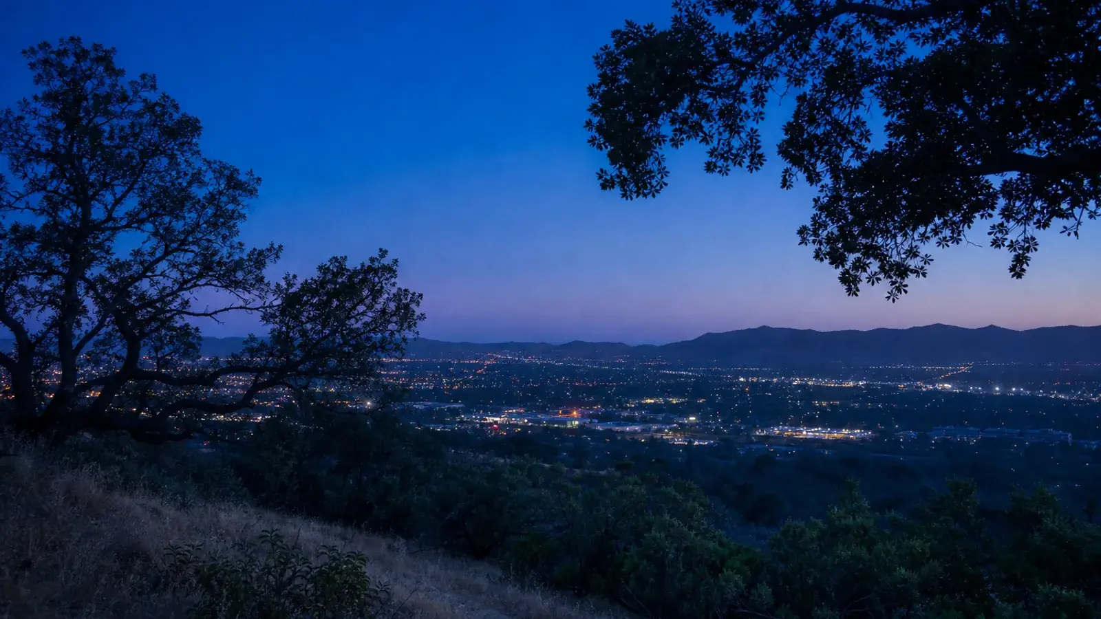 Woodland Hills oak hillside vista at blue hour — breast augmentation context Woodland Hills oak hillside vista at blue hour — breast augmentation context | SurgiSculpt®