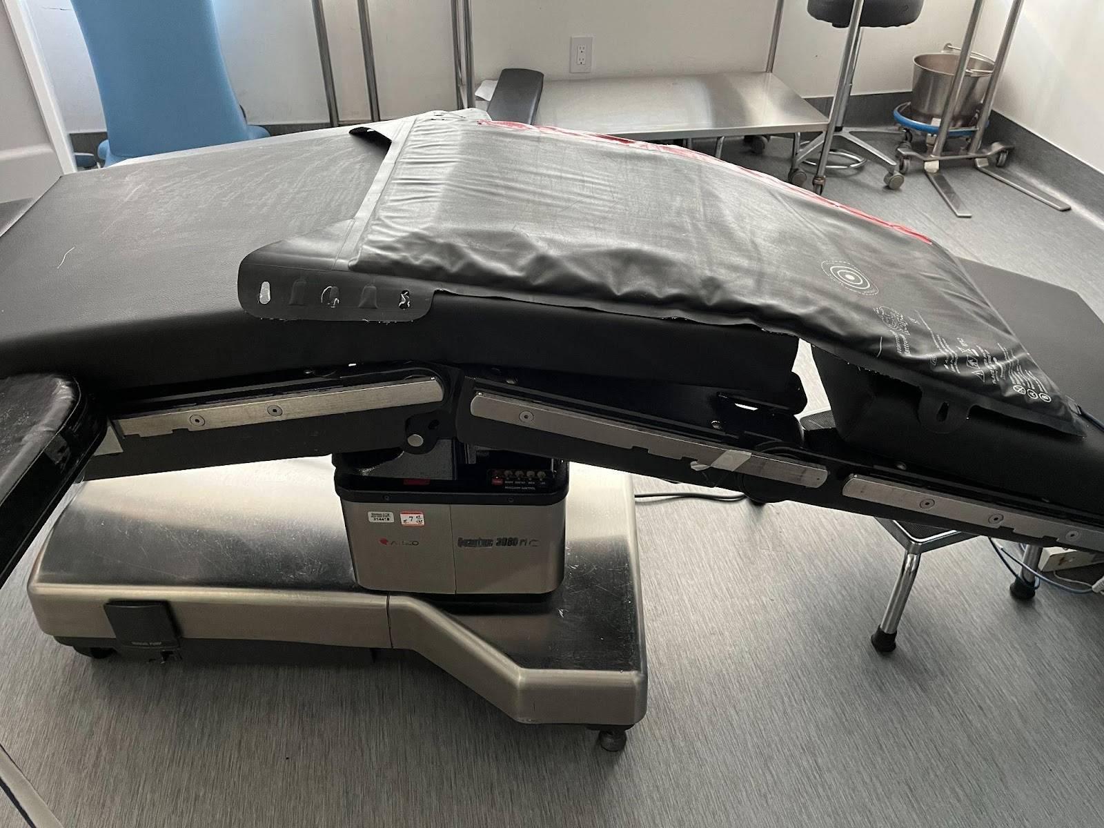 A medical table with a black cover on it, following the Safe BBL Protocol. A medical table with a black cover on it, following the Safe BBL Protocol.