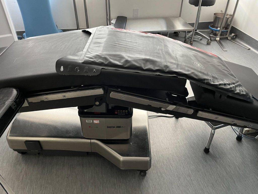 A medical table with a black cover on it, following the Safe BBL Protocol.